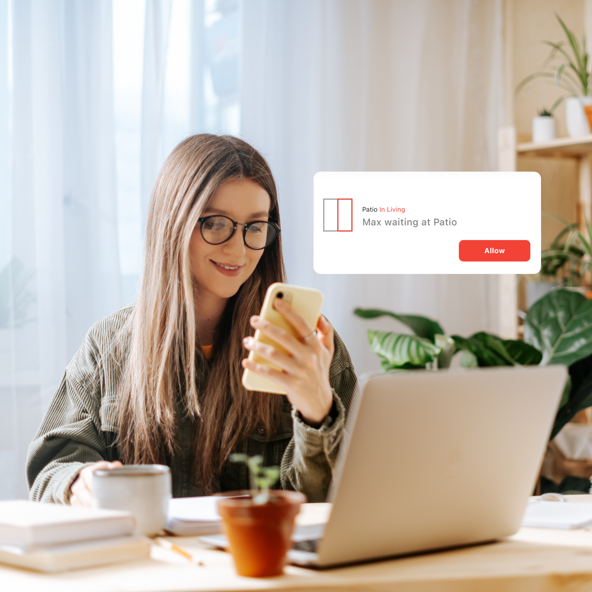 Image of a woman at her office desk receiving a SmartSlydr mobile app notification: her dog is waiting at the door, allowing her to remotely approve or deny entry.