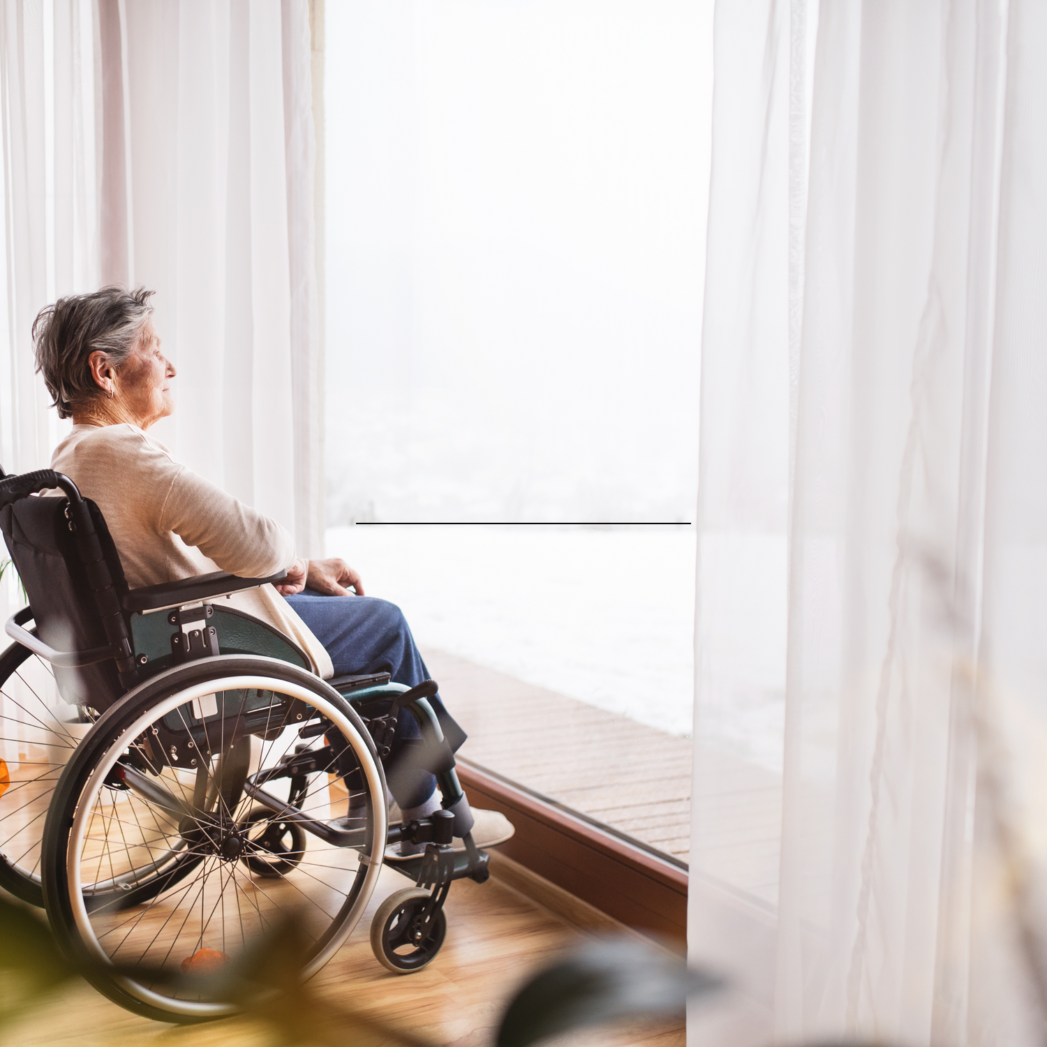 Accessible SmartSlydr automatic door being used by elderly wheelchair user.