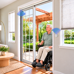 Man in a wheelchair approaches a sliding patio door as SmartSlydr opens it automatically, then rolls outside hands-free